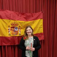 Abigail Boersma posing in front of Spanish flag